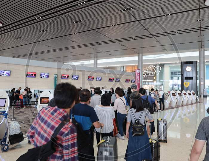Passengers In Queue Lines At Airport  Web Checkin Kisok