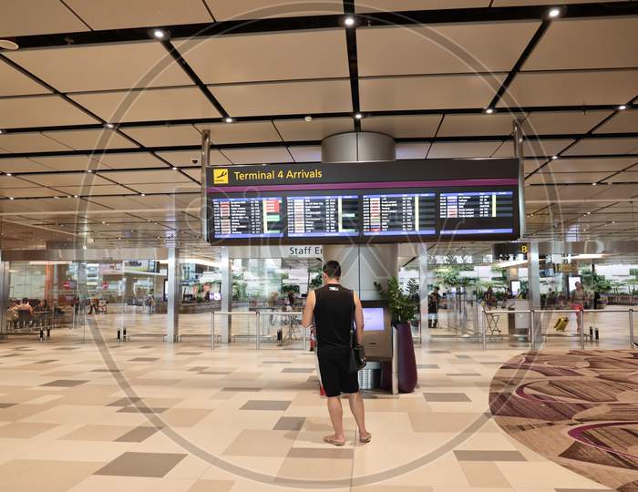 Terminal 4 Arrivals Board At Changi Airport, Singapore