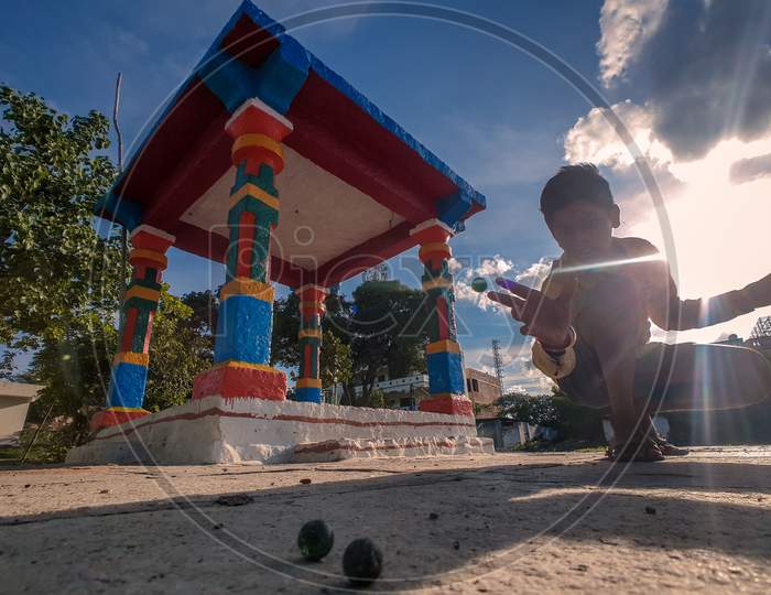 Indian little kid playing outdoor games
