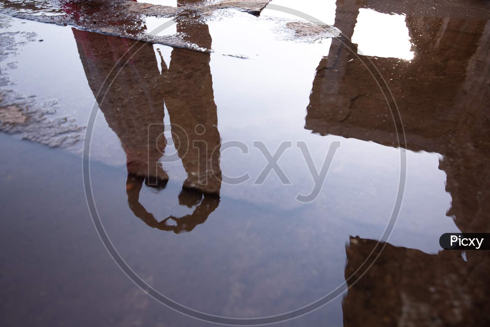 Reflection of  Couple On Water Surface