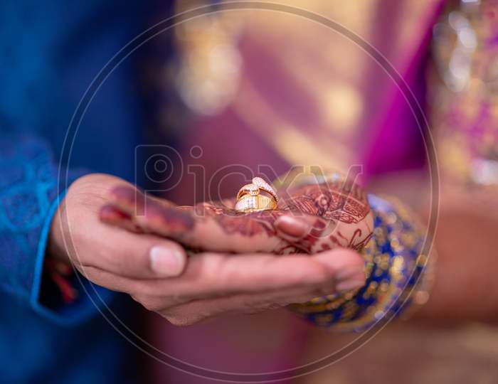 Wedding Couple Holding  Wedding Rings in Hand At Wedding Ceremony
