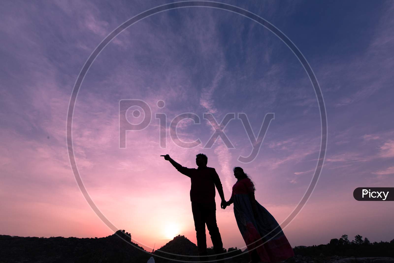 Silhouette of Indian newly married couple during a sunset
