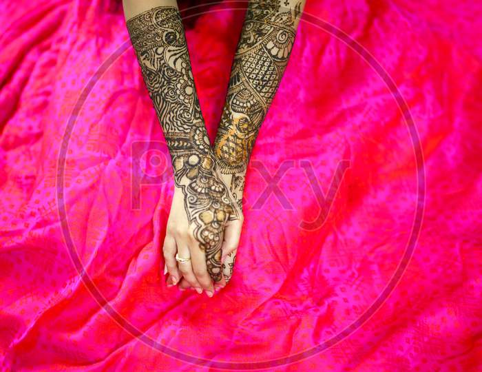 Indian Bride Showing Mehndi Hands With  Wedding Ring