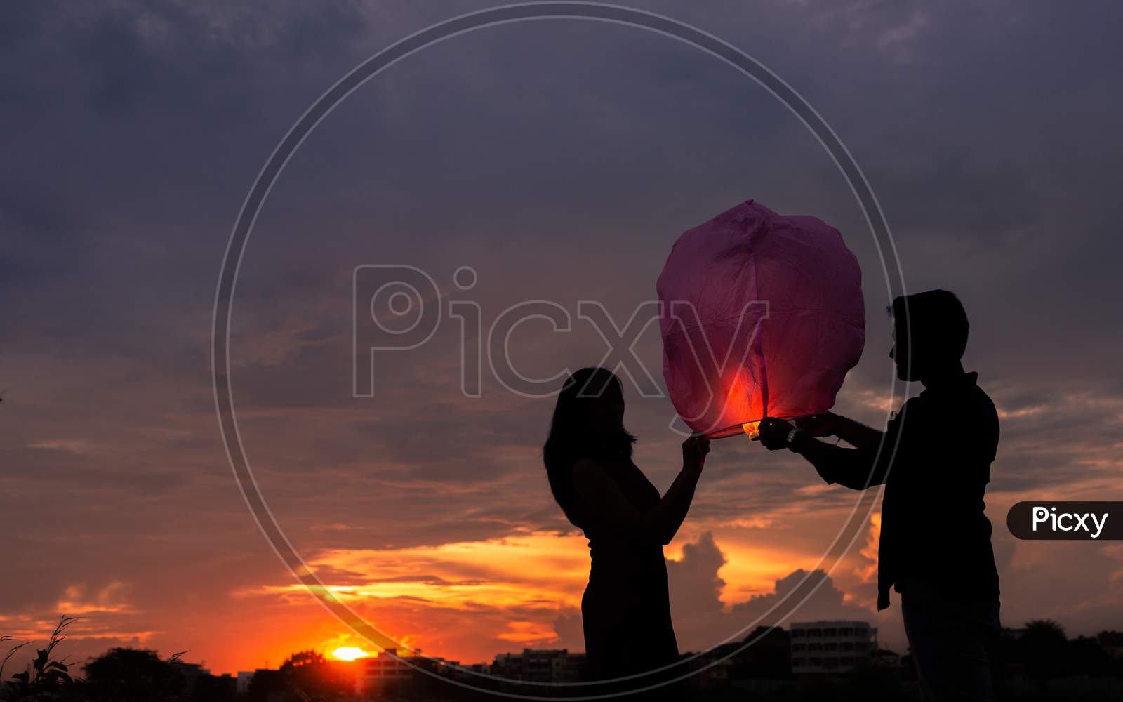 Silhouette of Indian couple holding lantern