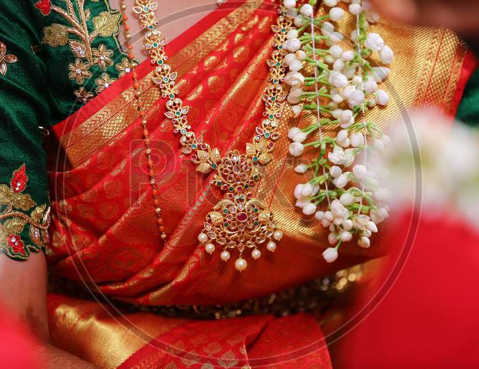 Indian Bride Wearing Golden Jewelery At Indian Wedding