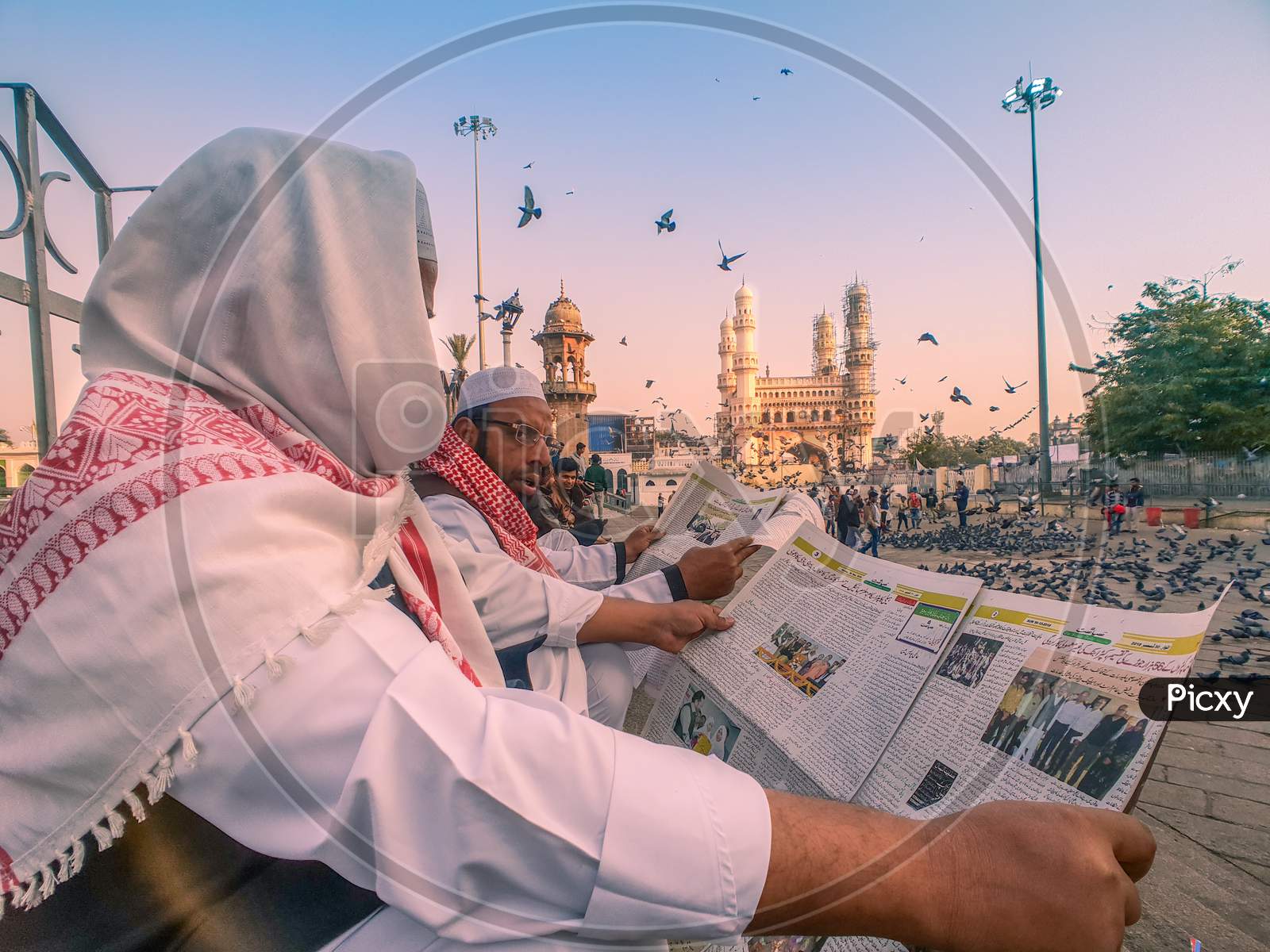 Indian Muslim reading a newspaper