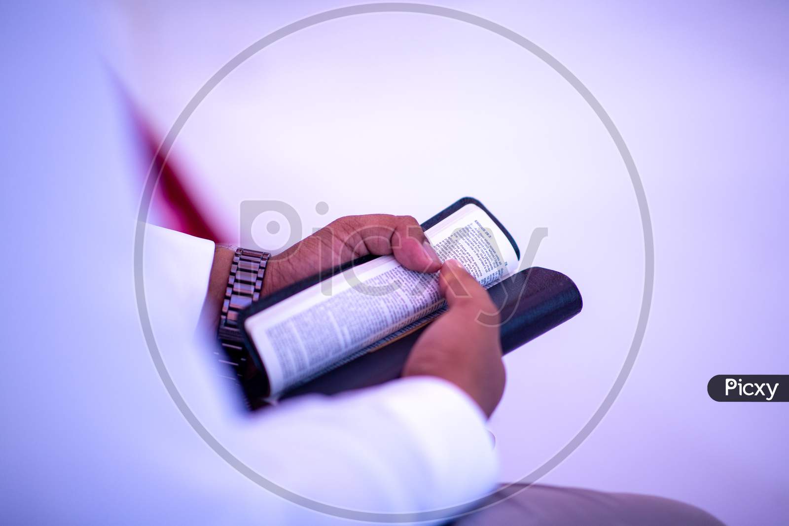 A Man Holding Bible In Hand At a Wedding
