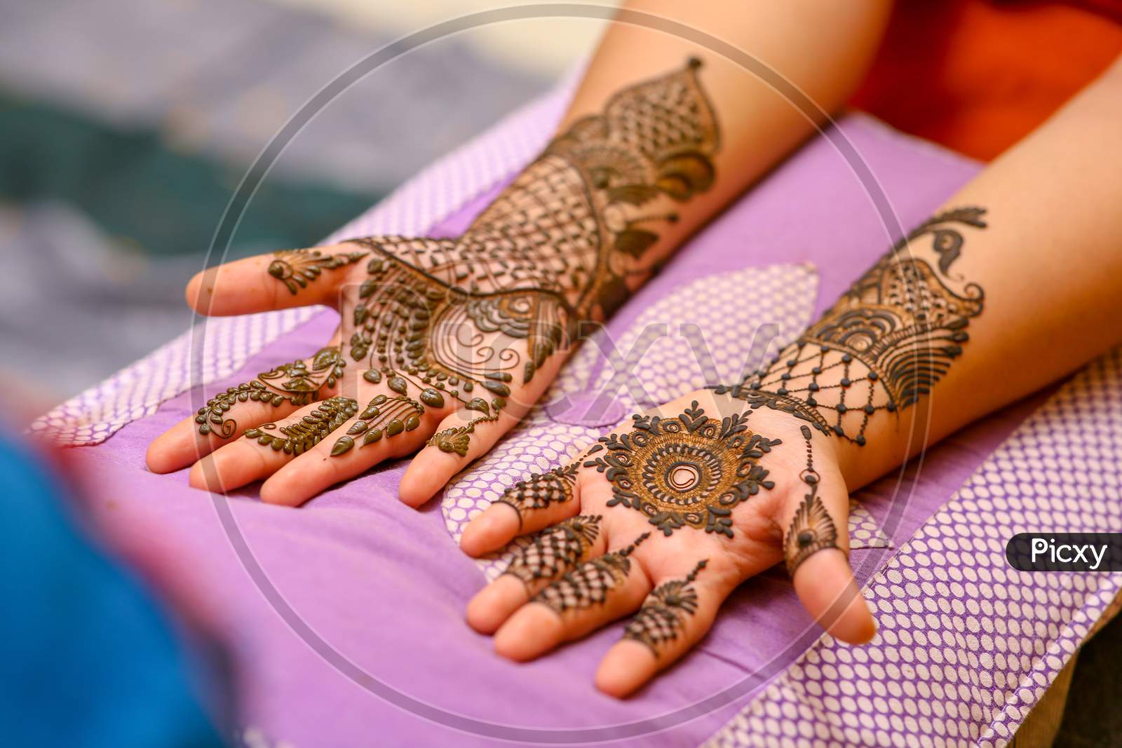 Mehndi  Artists  Making a Mehndi Design on Bridal hands on Her Wedding Day