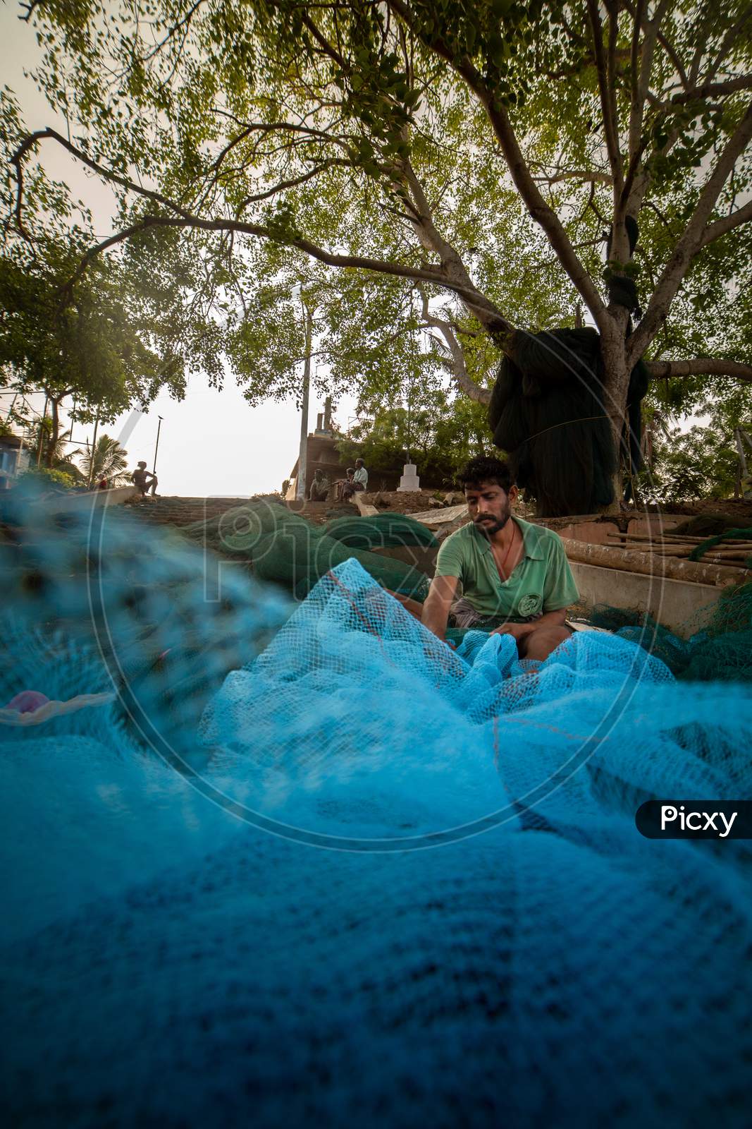 Indian fisherman weaving cast net