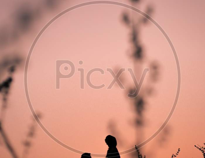 Silhouette of Indian newly married couple during sunset