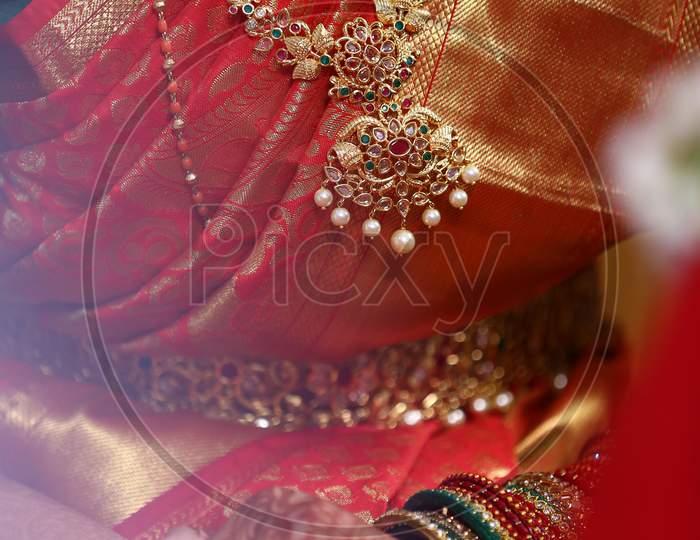 Indian Bride Wearing Golden Jewelery At Indian Wedding