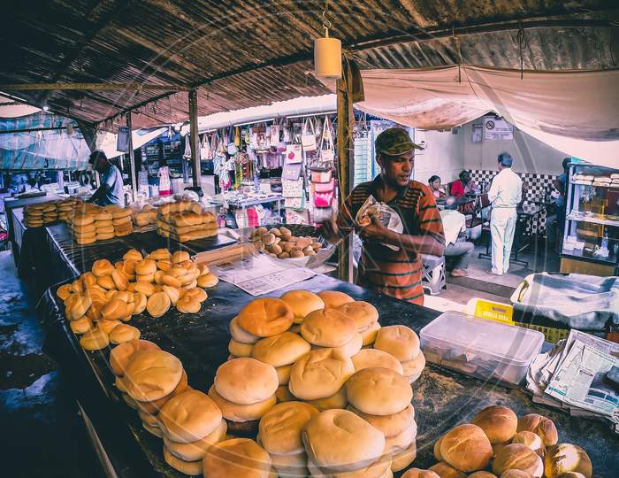 A Local bread seller called "Poder" in Mapusa Market, Goa