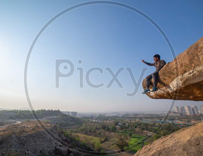 Indian Traveler sitting by the cliff