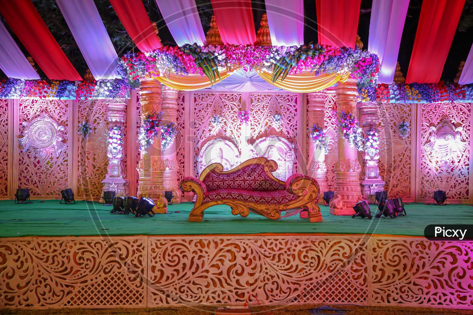Decorated Stages With Lights And Flowers At Indian Weddings