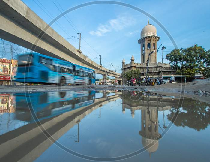 Reflection of a bus and metro rail bridge in the water