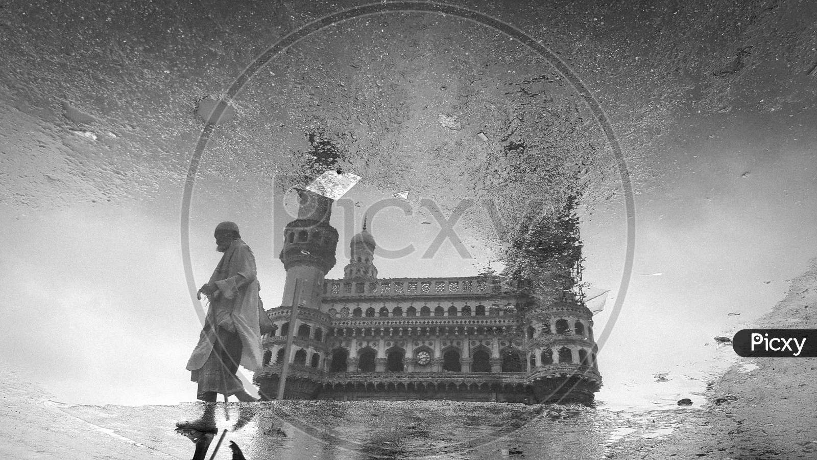 An Old Man Reflection On Water Surface At Charminar