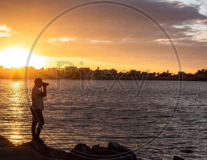 Indian Photographer Man shooting during sunset