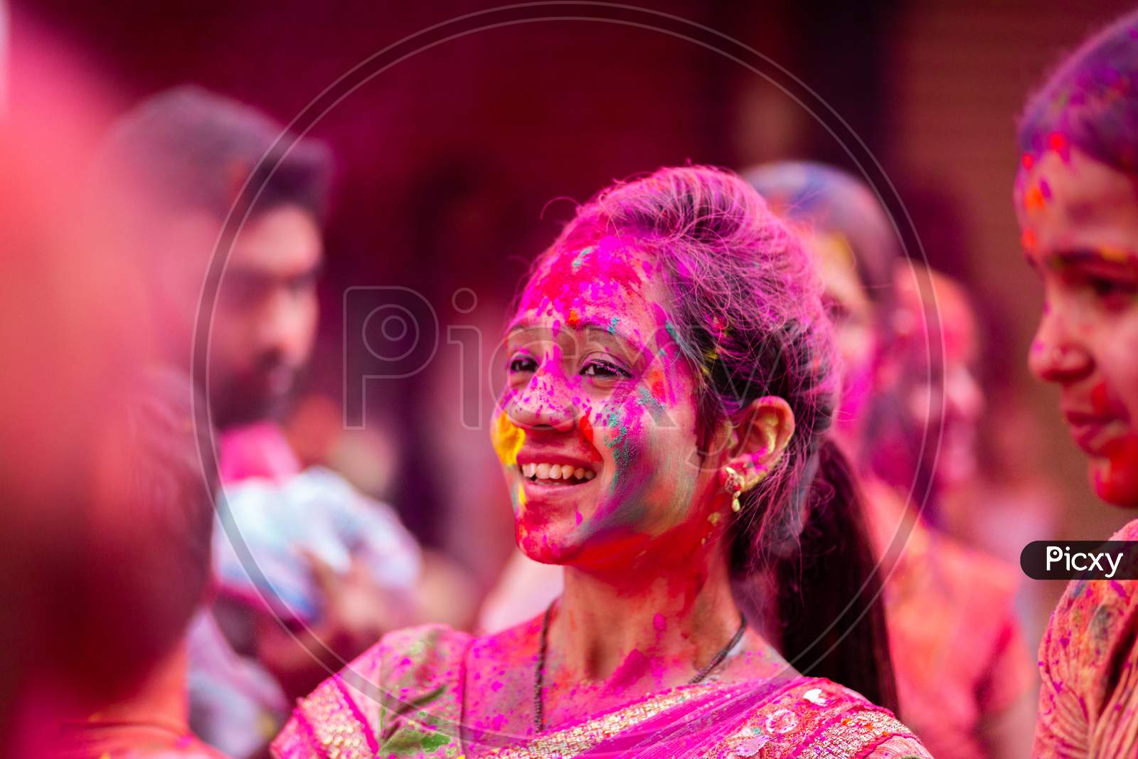 Portrait of Indian girl with pink color during holi