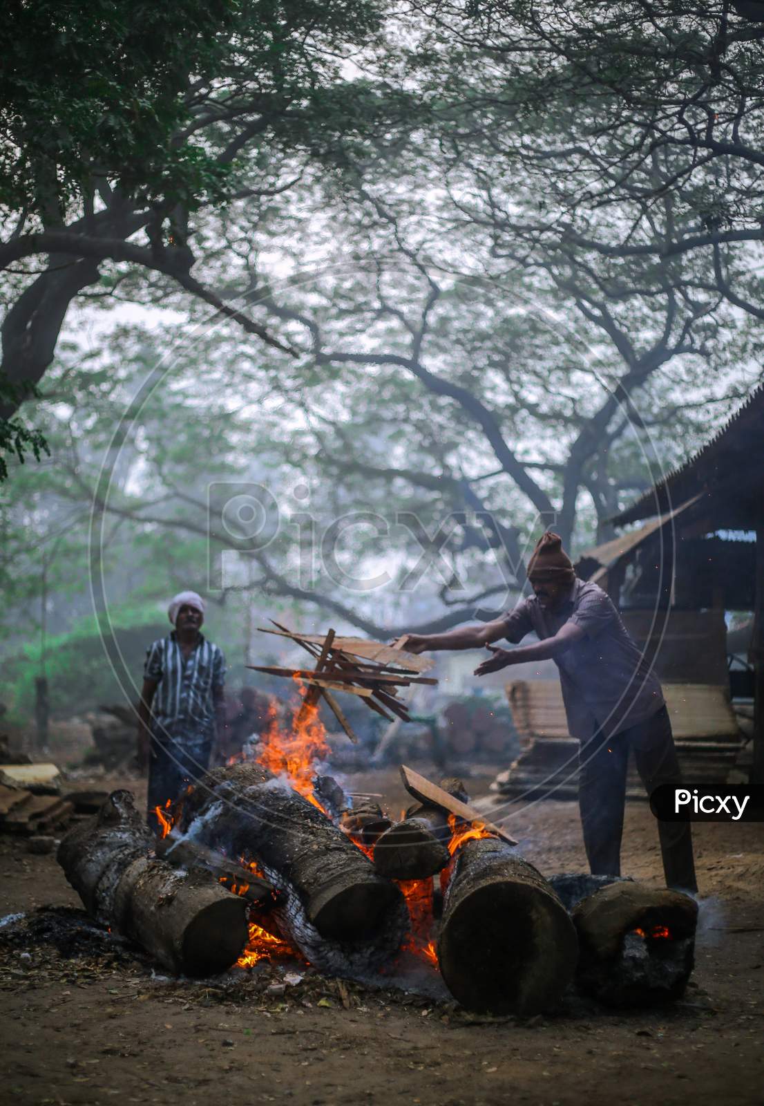 Indian men setting up Bhogi bonfire
