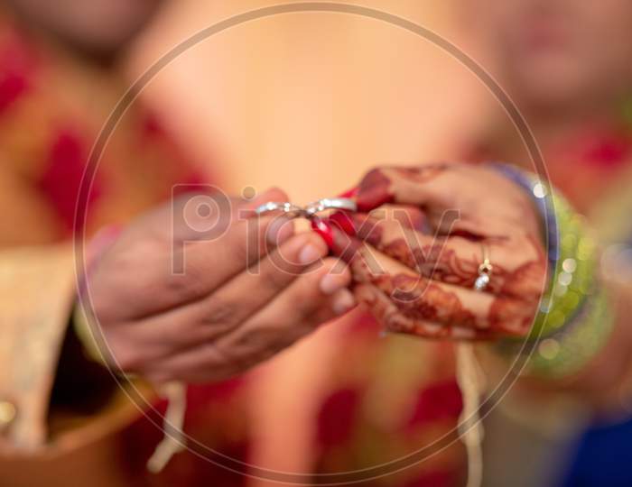 Wedding Couple Exchanging Rings At an Engagement Ceremony