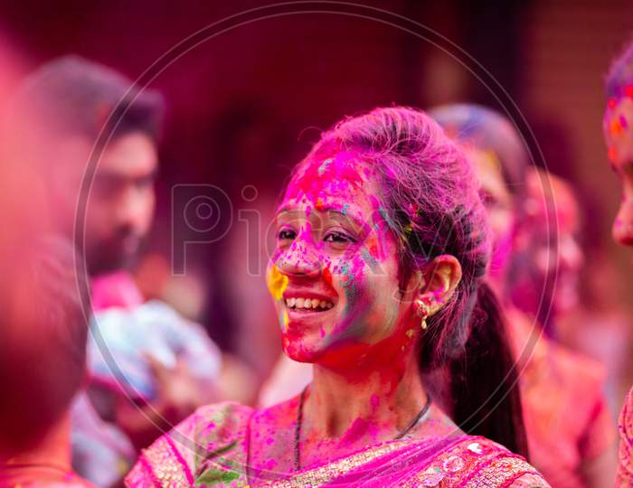 Portrait of Indian girl with pink color during holi