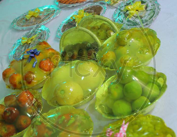 Traditional Plates in an Indian Wedding Ceremony With Sweets And Fruits Wrapped