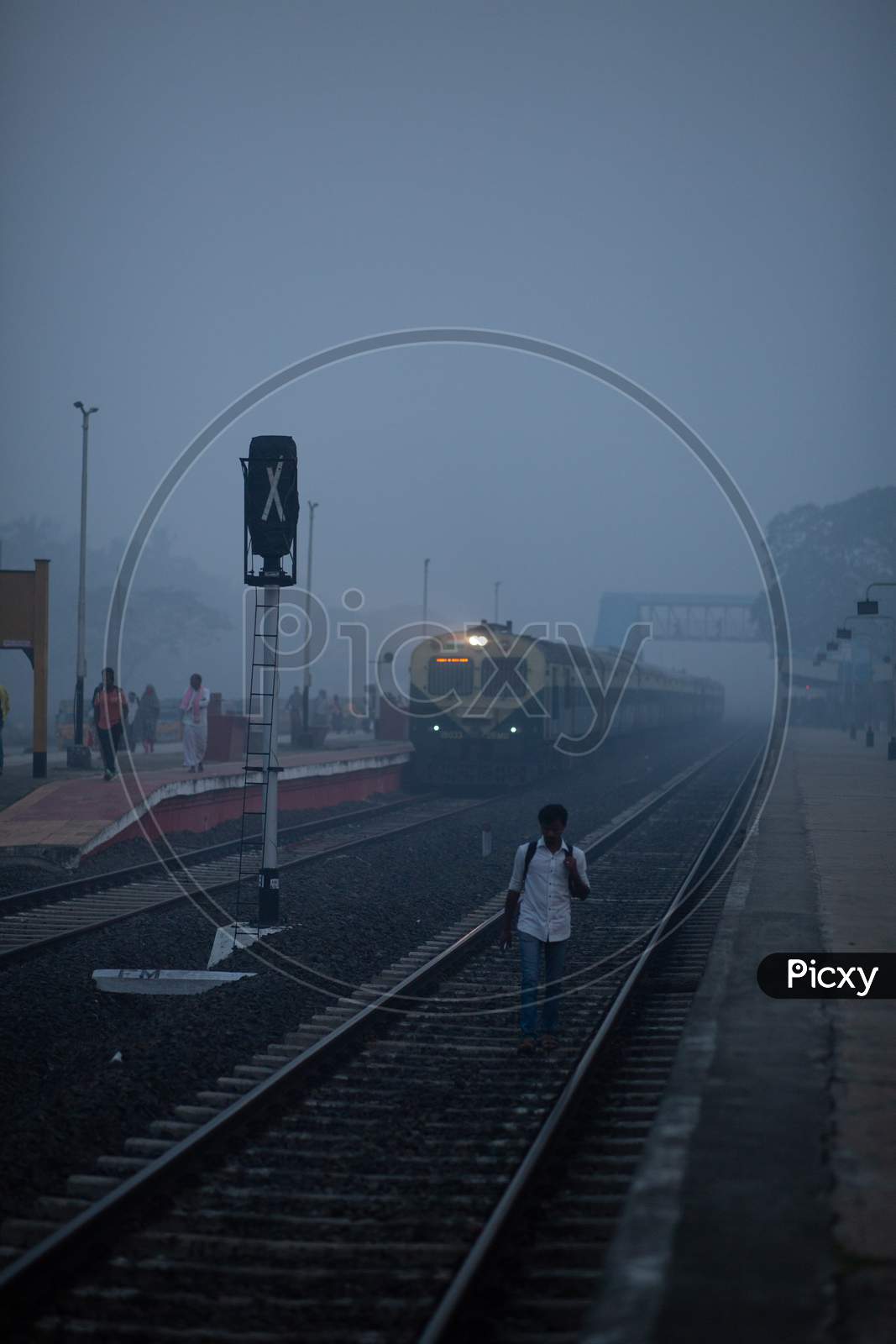Indian Man walking along the Railway Track