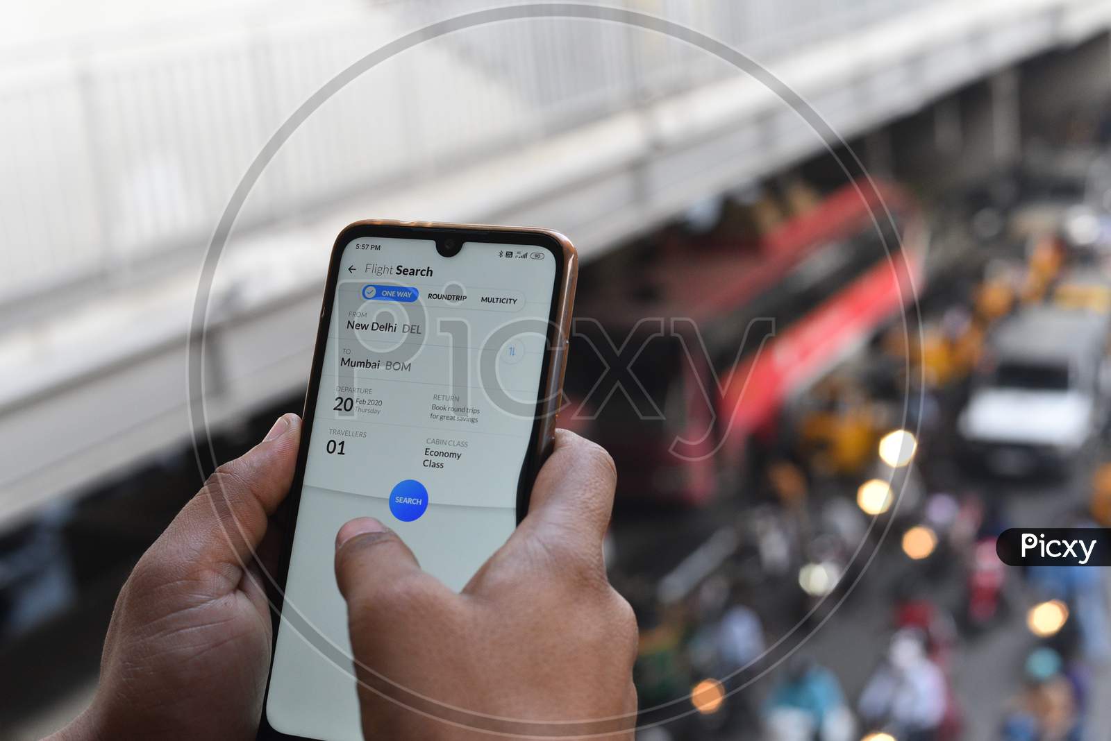Indian Man searching flight tickets in ixigo app