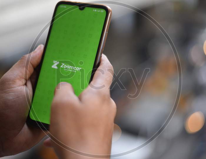 Indian Man using Zoomcar app on the mobile