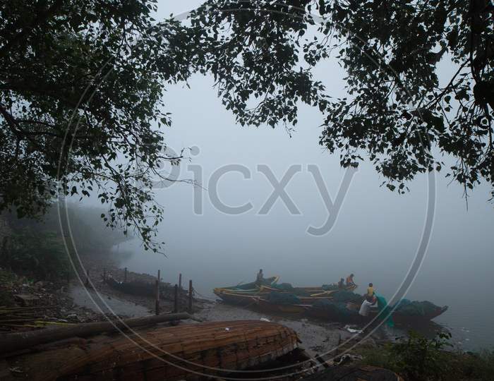 View of boats by the river during early morning