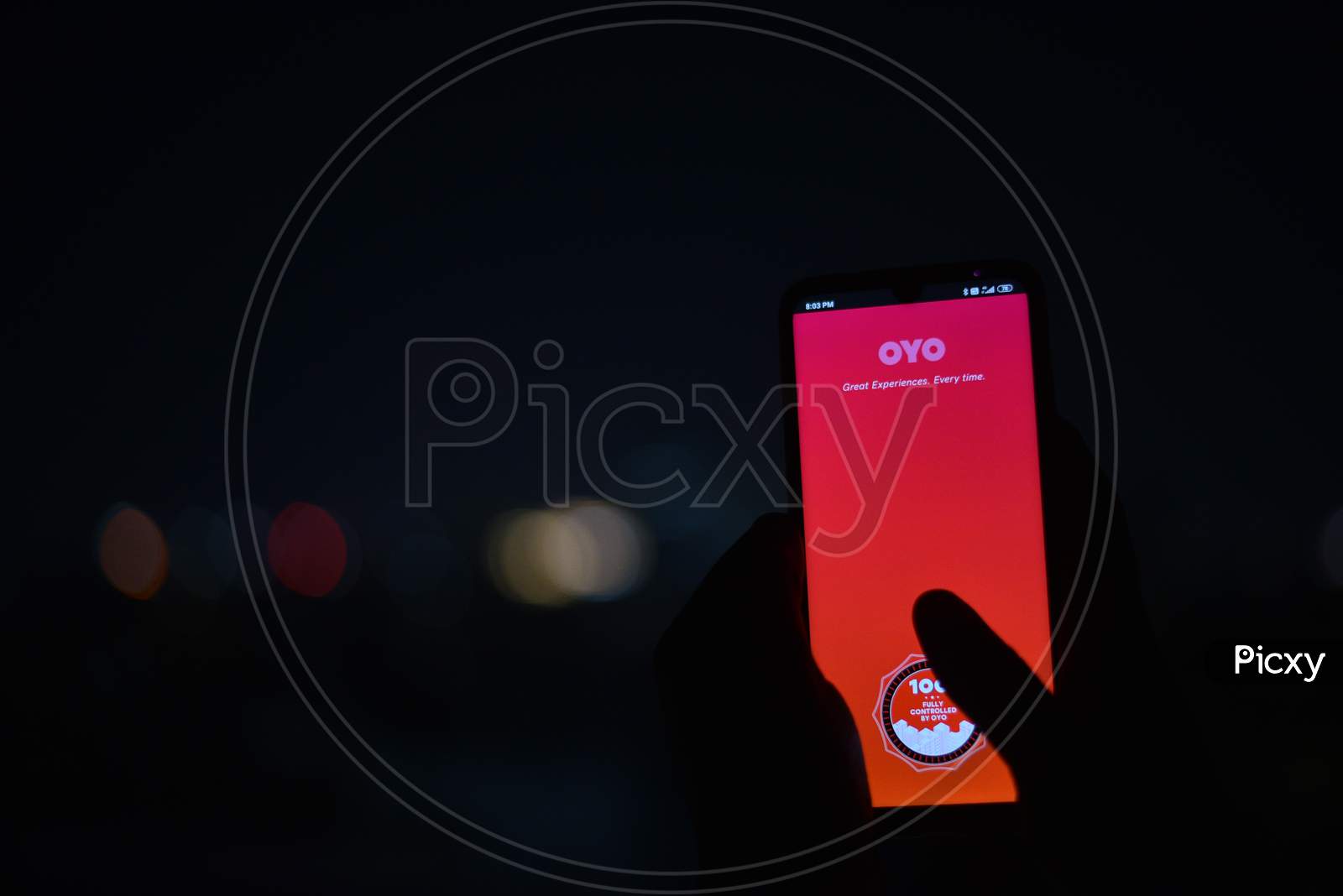 Indian man using OYO rooms app in the dark