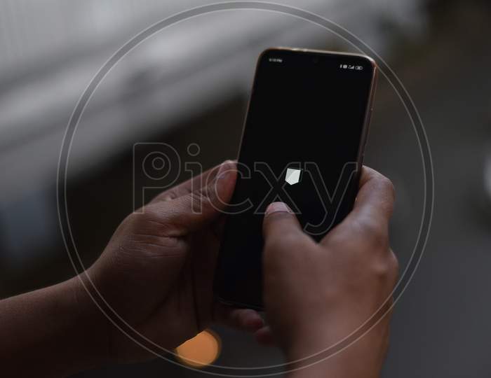 Indian Man using android phone in Dark Mode