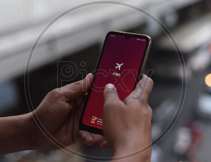 Indian Man opening ixigo mobile app