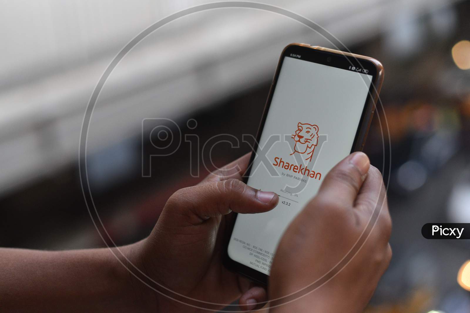 Indian Man installing ShareKhan app on the Android Phone