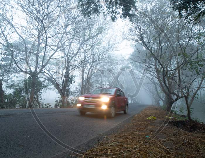 A car moving along the foggy road
