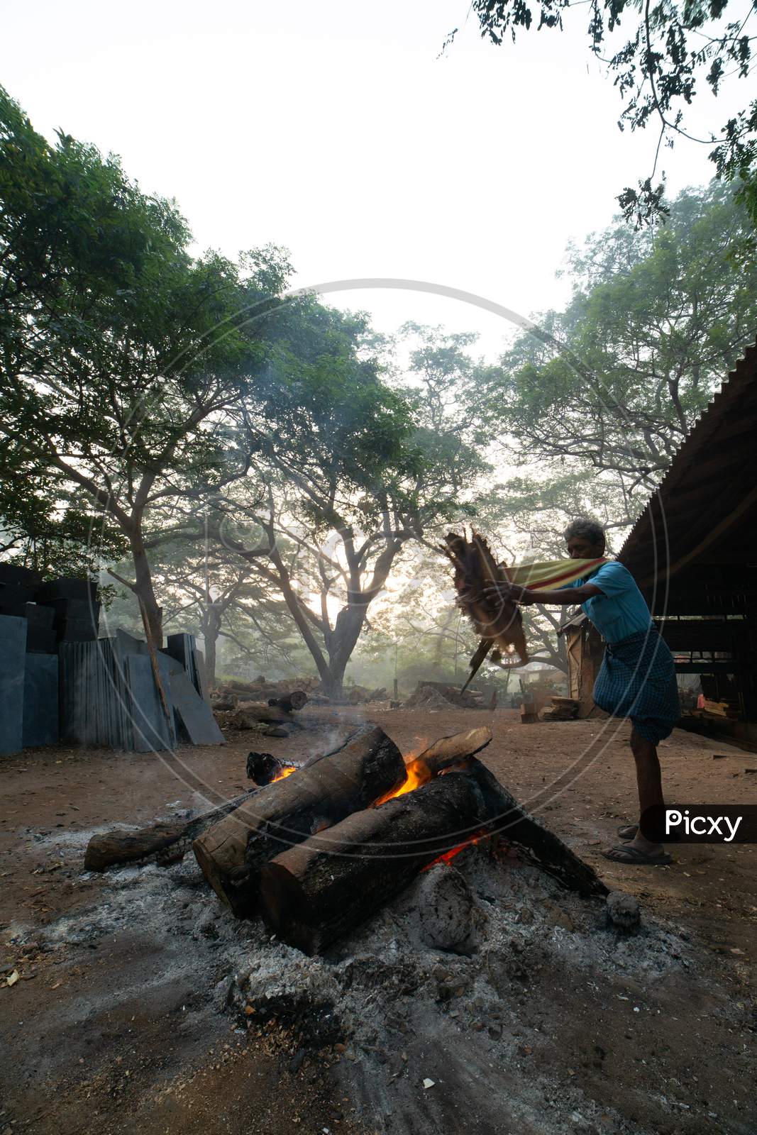 Indian Old Man setting up the Bhogi bonfire