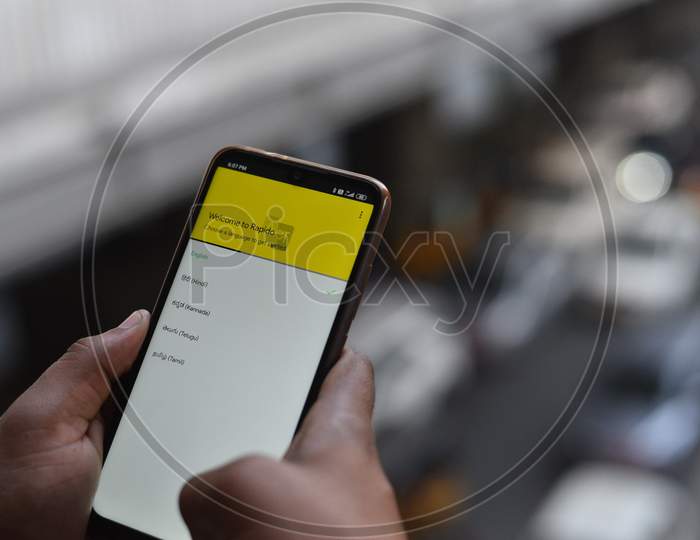 Indian Man registering with Rapido Bike Taxi app