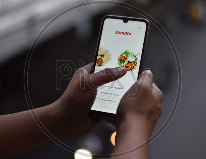 A Mobile Phone with Zomato main menu display