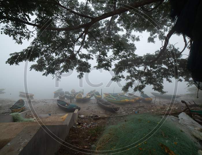 Landscape of wooden boats during fog