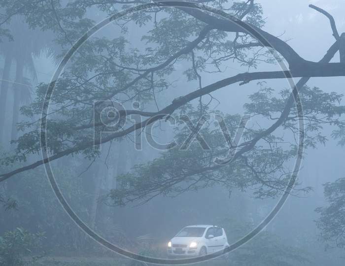 A car moving along the foggy road in Palakollu
