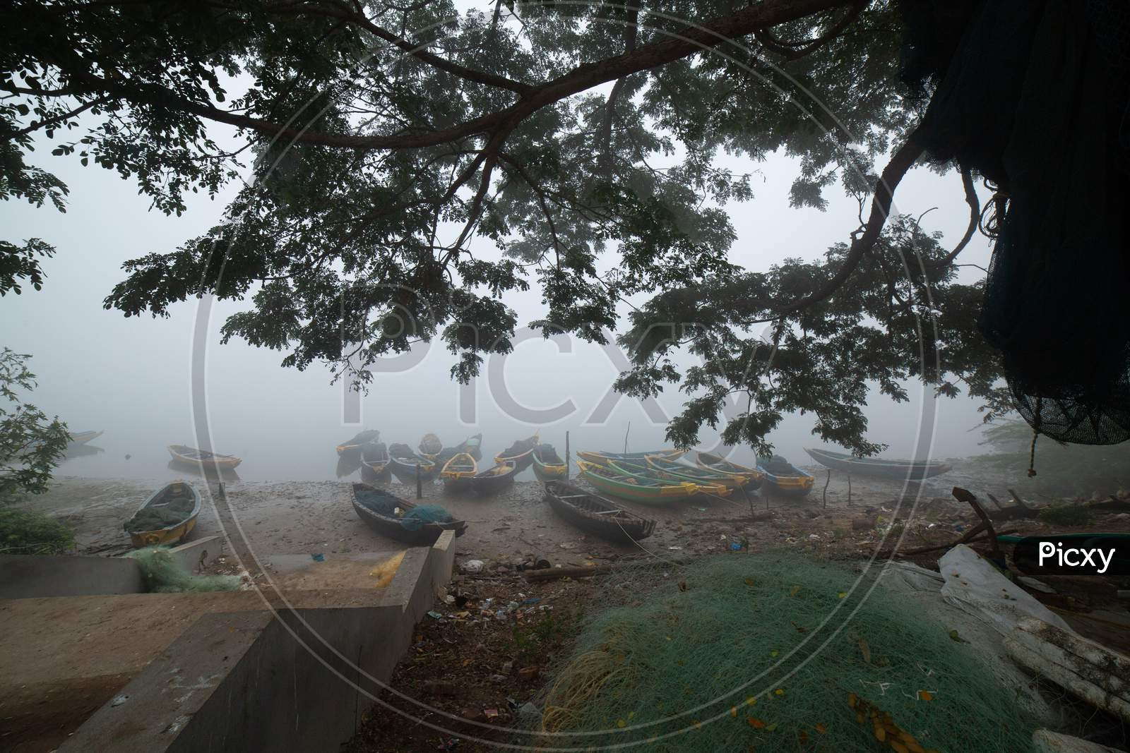 Landscape of wooden boats during fog