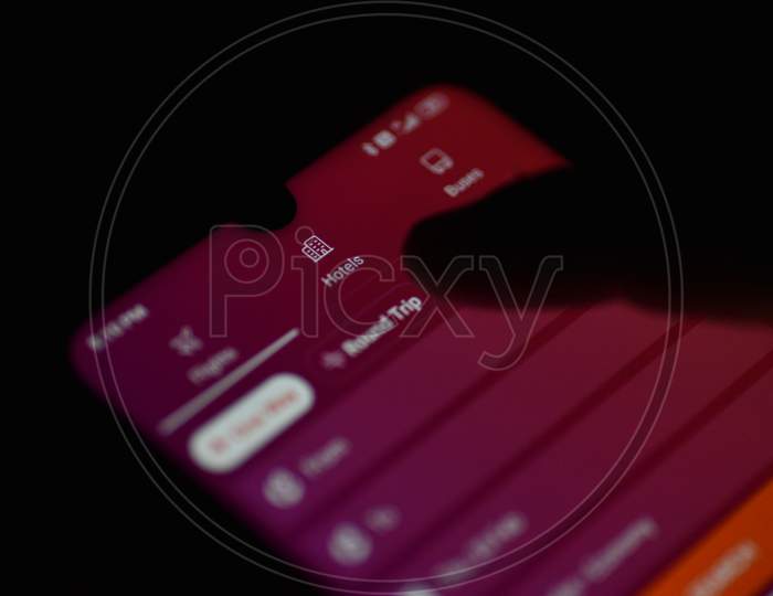 Indian Man booking tickets on ixigo app