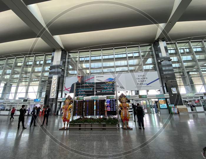 Entrance Terminal At Bangalore International Airport  With Passengers Carrying Luggage Bags