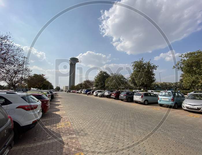 ATC  Tower With Cars  Parked In an Paring Lot At Bangalore International Airport