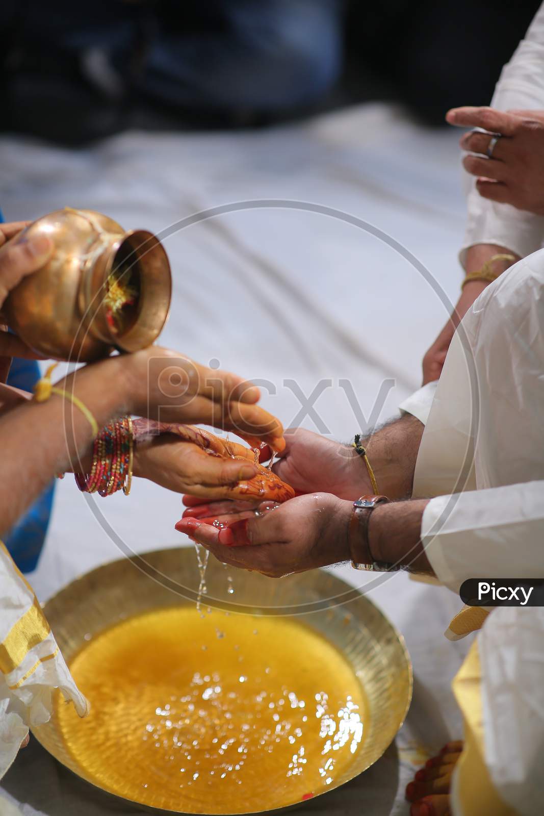 South Indian Bride Groom washing hands during wedding puja