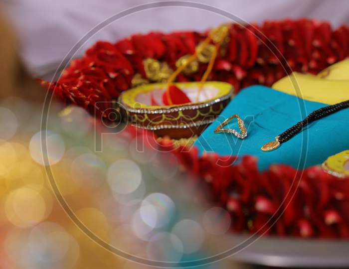 Engagement ring and other necklace during wedding puja