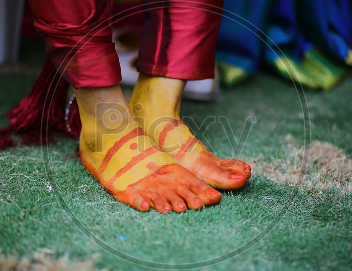 Turmeric on the legs of Indian bride