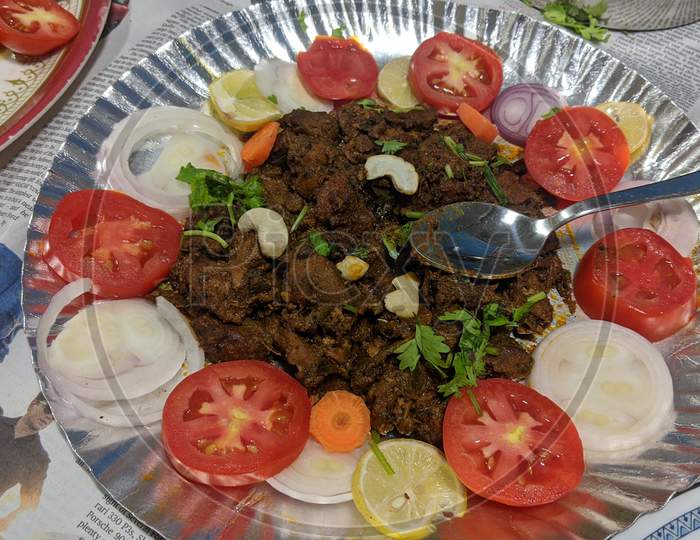 Indian Mutton fry garnishes with tomatoes