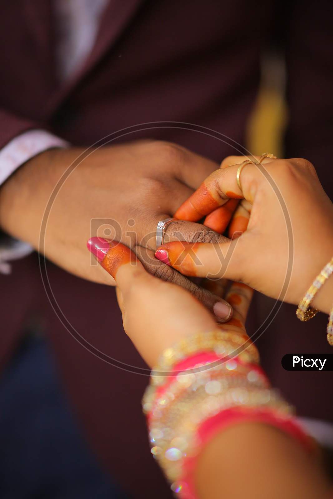 Indian bride putting ring during wedding