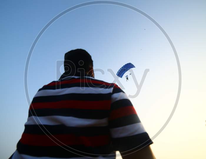 Indian man spectating the paragliding